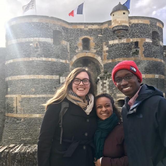 Three Paris Civ in French students stand in front of the Château d’Angers on a sunny day