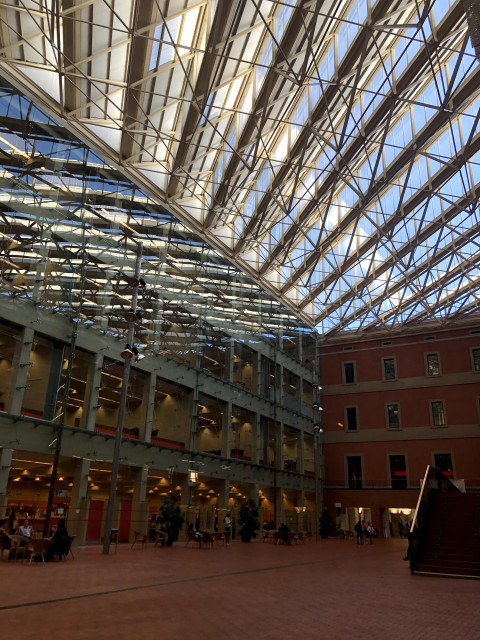 A view from inside a building on the UPF campus, with its dramatic glass ceiling.