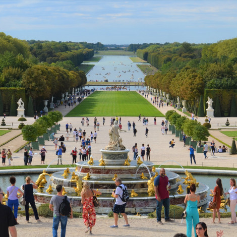 View of Versailles gardens with many tourists